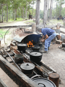 Bushie tends the camp fire at Herberton Historical Village. 